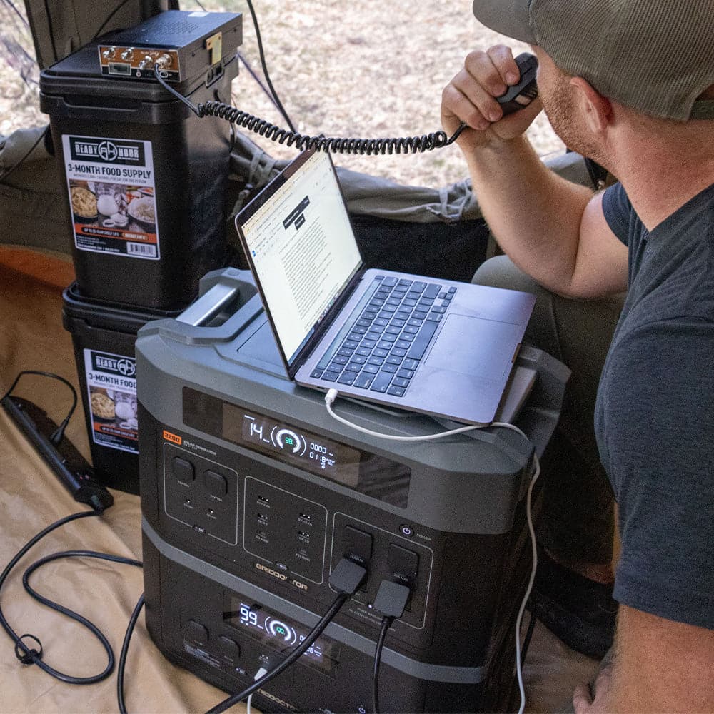 A laptop being powered by the emergency solar generator system, illustrating the system's capability to supply electricity to personal electronic devices.