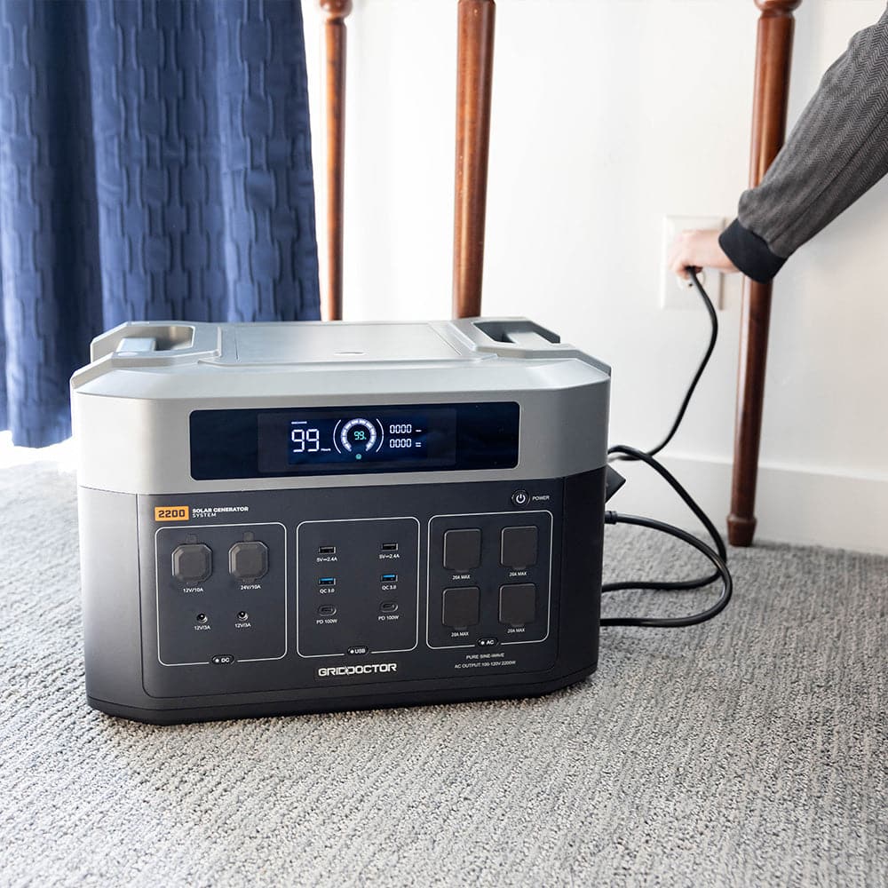 2200 battery connected to a wall charger in a home setting, indicating charging in progress.