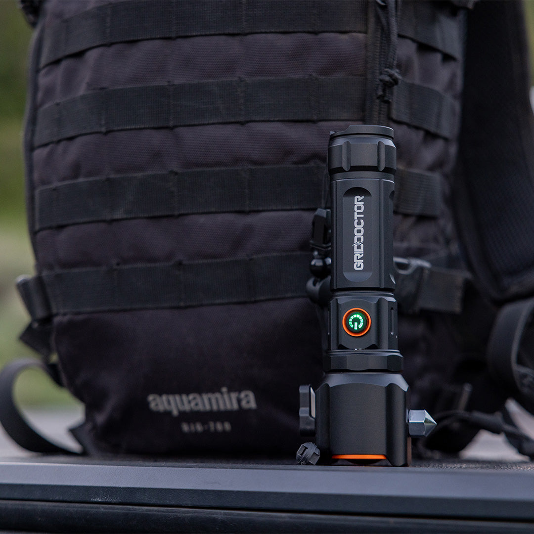 Grid Doctor Survival 1K-LM Flashlight attached to backpack molle webbing for hands-free carry
