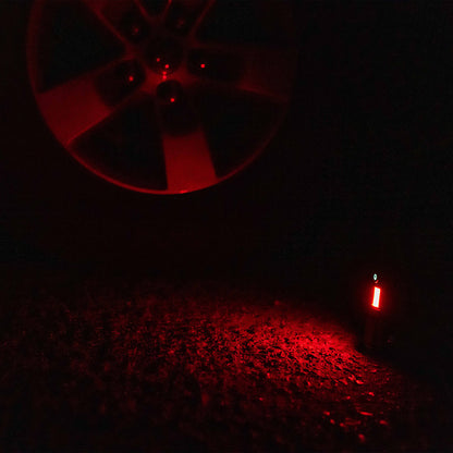 Grid Doctor Survival 1K-LM Flashlight in red emergency warning light mode on pavement
